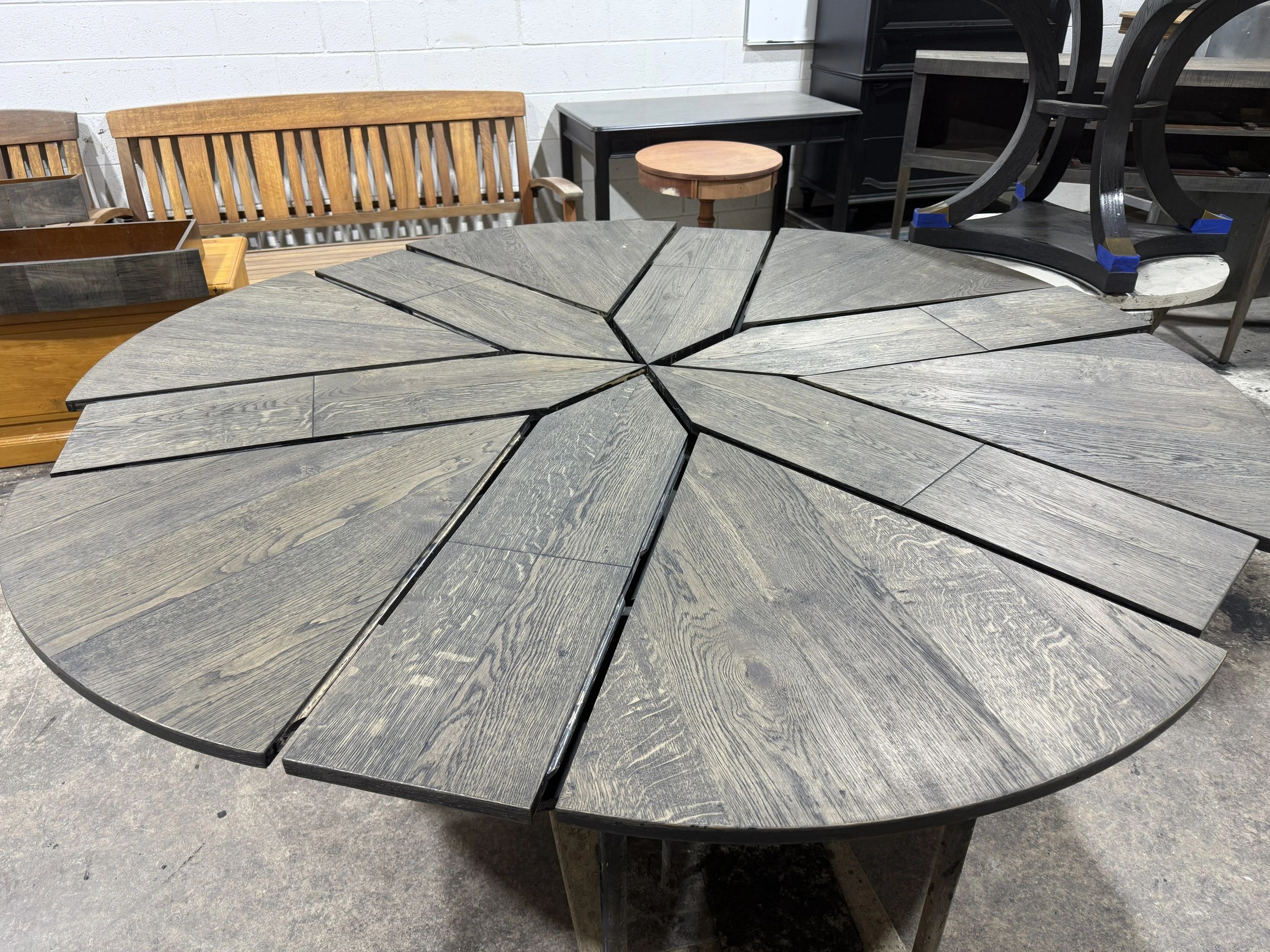 Circular expandable dining table with sunburst design